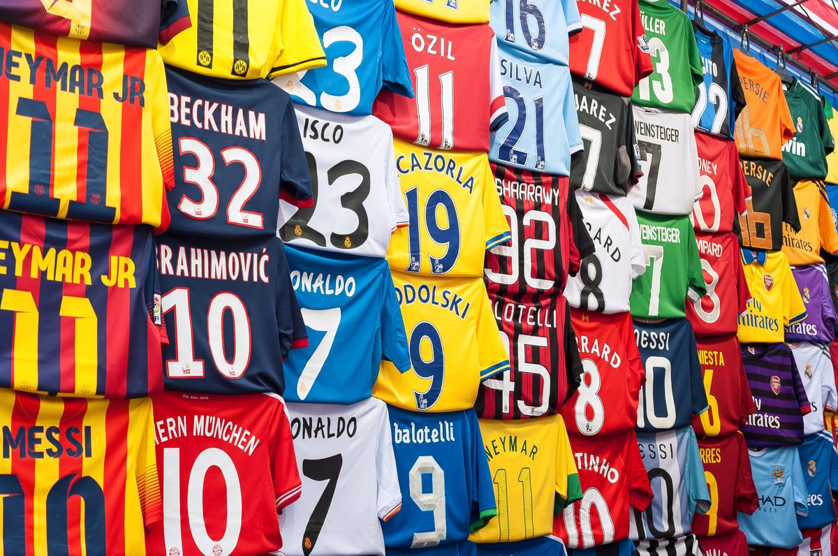 A rail of football shirts at a market stall