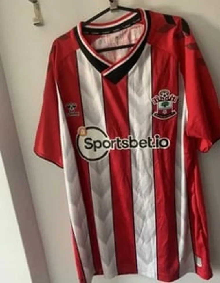 Red and white striped Southampton football shirt on a hanger